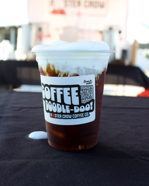 Pouring a cold brew coffee from Rooster Crow Coffee at a local market, highlighting our refreshing iced coffee offerings and community presence